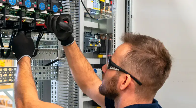 Electrician working on electric cabinet